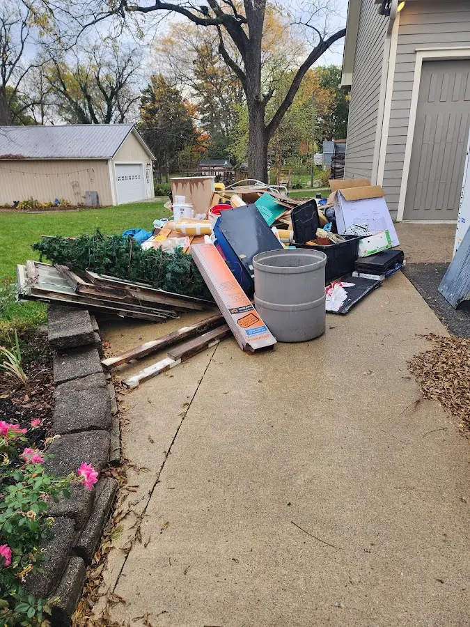 Dumpster being loaded with debris for Estate Cleanout Dumpster Rental in Canisteo